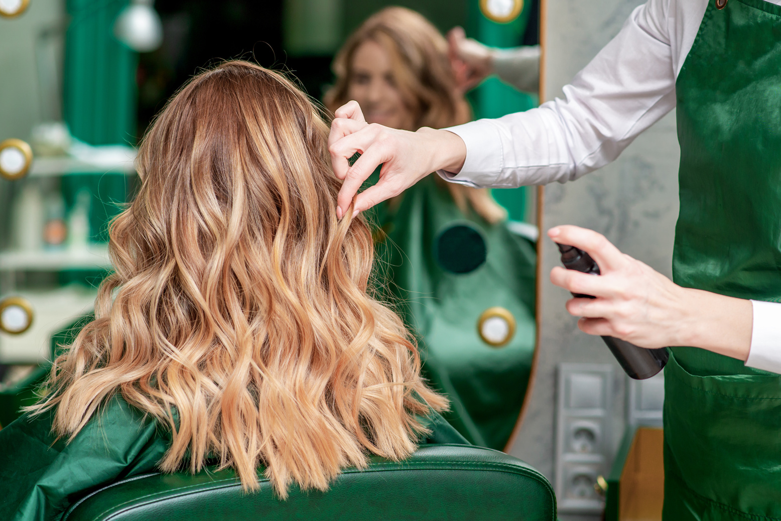 Hairdresser makes hairstyle.